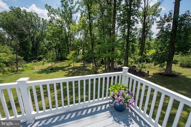 wooden deck featuring a yard