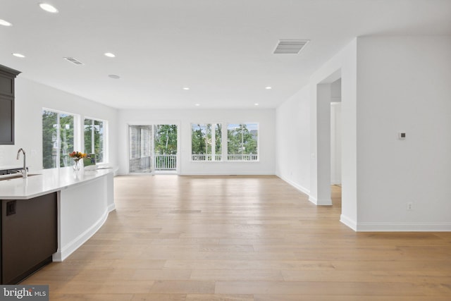 kitchen with sink and light hardwood / wood-style flooring