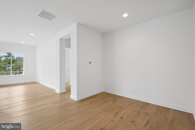 unfurnished room with light wood-type flooring