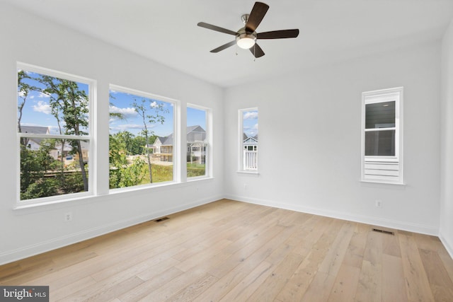 empty room featuring ceiling fan and light wood-type flooring