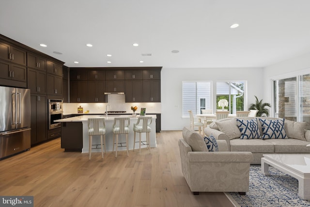 living room with sink and light hardwood / wood-style floors