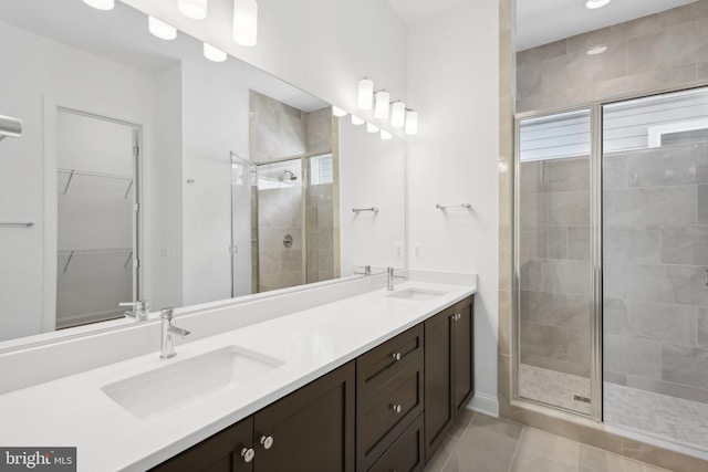 bathroom with vanity, tile patterned flooring, and a shower with door