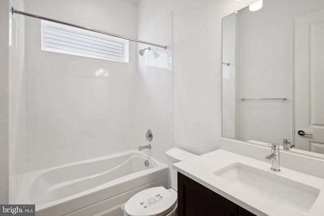 full bathroom with toilet, tiled shower / bath combo, and vanity