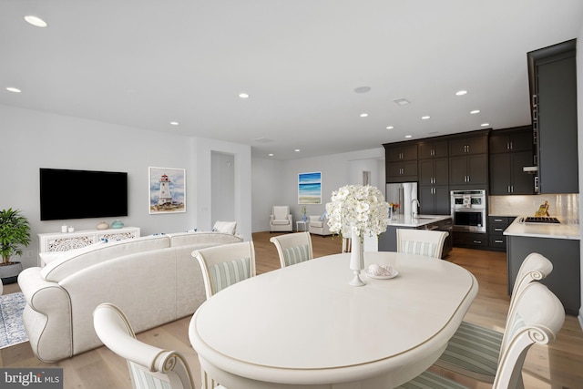 dining space featuring sink and hardwood / wood-style flooring