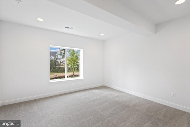 unfurnished room featuring light carpet