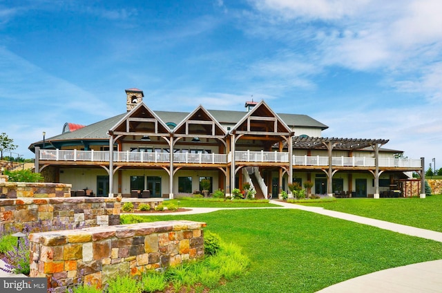 exterior space with a front lawn and a pergola