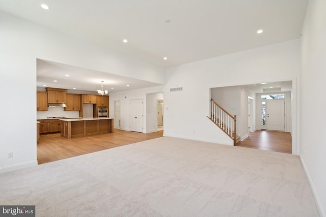 5095 Maple Ridge Way, Emmaus, PA 18049 - unfurnished living room with light colored carpet, recessed lighting, stairway, and baseboards