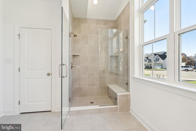 bathroom with tile patterned flooring and walk in shower