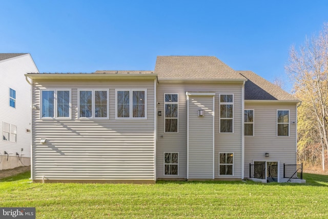 rear view of property with a yard