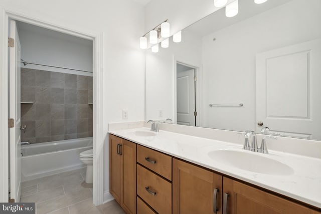 full bathroom with tile patterned flooring, vanity, toilet, and tiled shower / bath combo