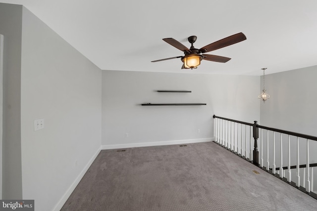 spare room featuring carpet flooring and ceiling fan