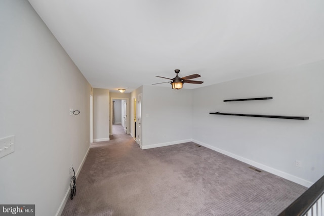 spare room featuring carpet flooring and ceiling fan