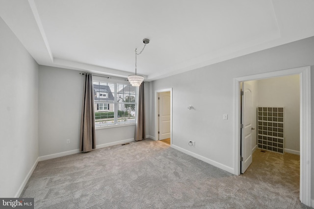 interior space featuring a chandelier and a tray ceiling