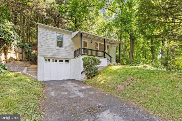 view of front of property with covered porch and a garage