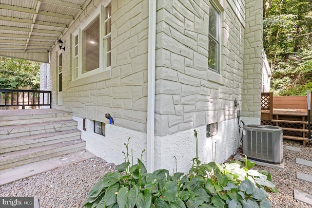 view of side of home featuring central air condition unit