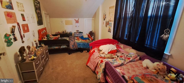 carpeted bedroom with lofted ceiling