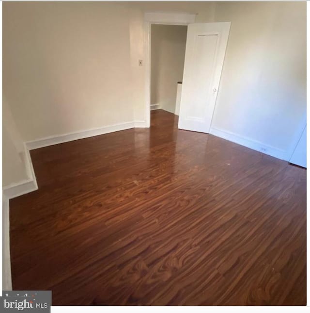 empty room featuring dark hardwood / wood-style flooring