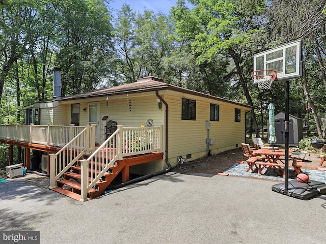 rear view of house with a patio and a deck