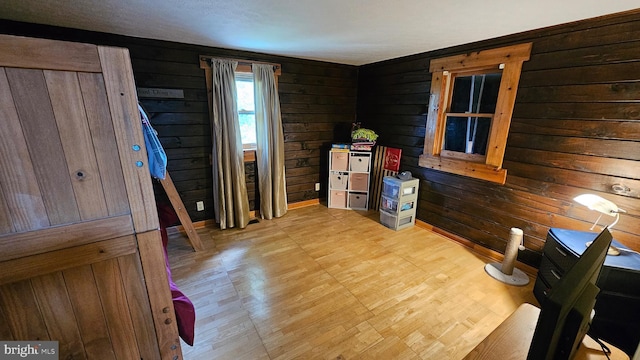 interior space featuring wooden walls and light hardwood / wood-style flooring