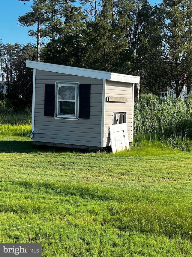 view of outbuilding with a lawn