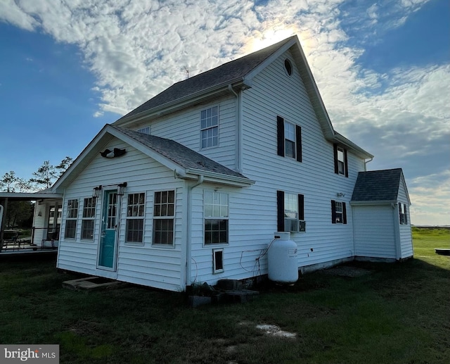 rear view of property featuring a lawn