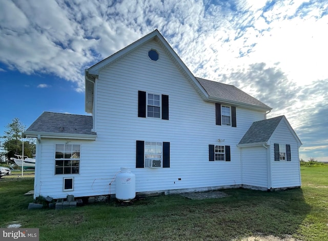 back of property featuring cooling unit and a yard