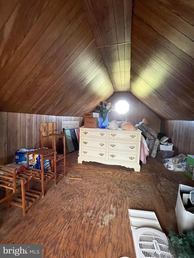 interior space with vaulted ceiling, wooden ceiling, and wood walls