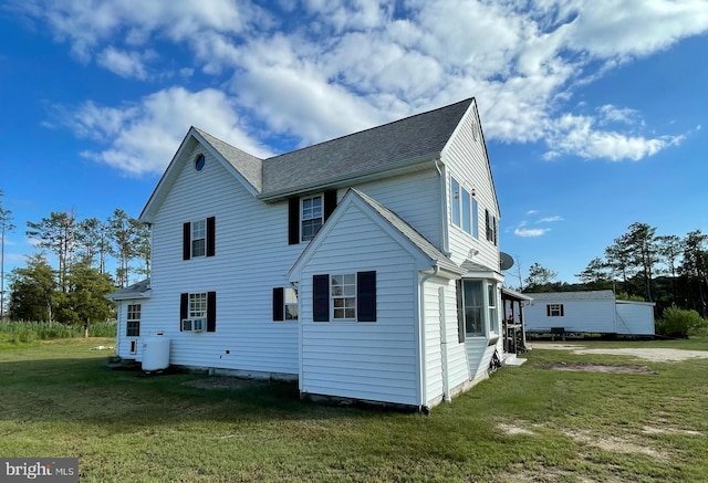 back of property with a lawn