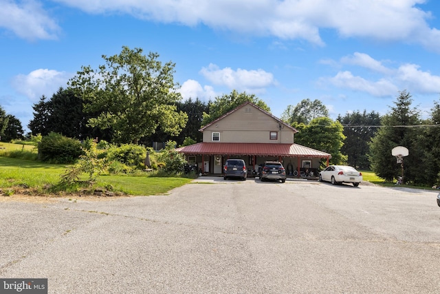 484 Brough Rd, Abbottstown, PA 17301 - view of property exterior with uncovered parking, a metal roof, and a lawn