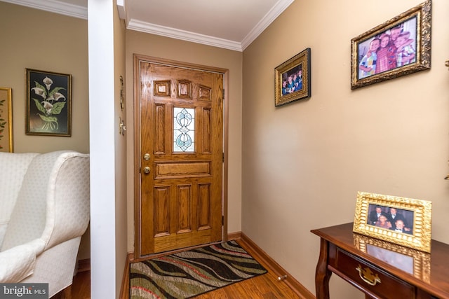 foyer with hardwood / wood-style floors and crown molding