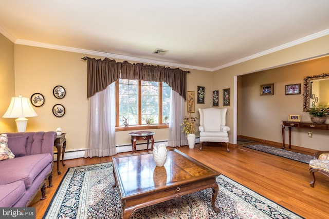 living room featuring wood-type flooring, baseboard heating, and crown molding