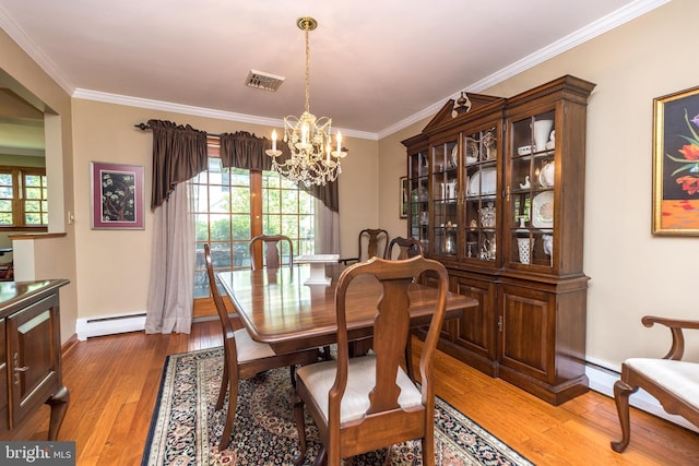 dining area featuring crown molding, wood-type flooring, baseboard heating, and an inviting chandelier