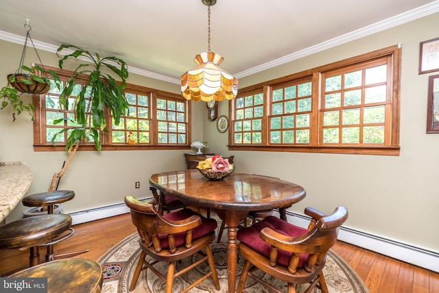 dining room featuring crown molding, a baseboard radiator, and hardwood / wood-style flooring