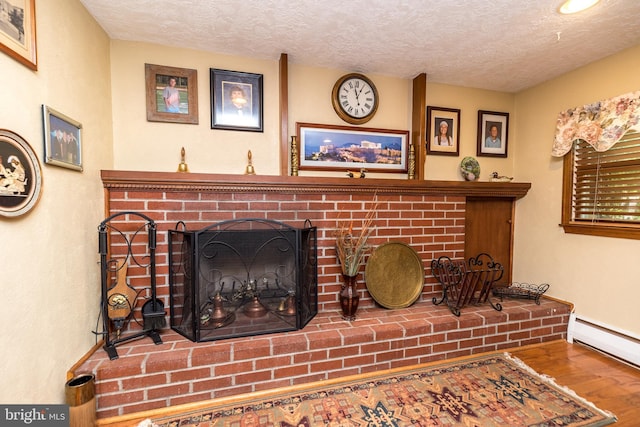 interior details with hardwood / wood-style flooring, baseboard heating, and a fireplace