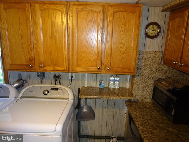 laundry area with cabinets and washing machine and clothes dryer