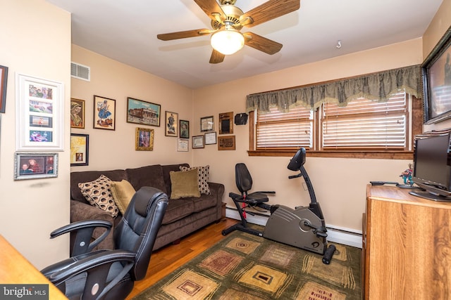 office featuring baseboard heating, ceiling fan, and dark hardwood / wood-style floors