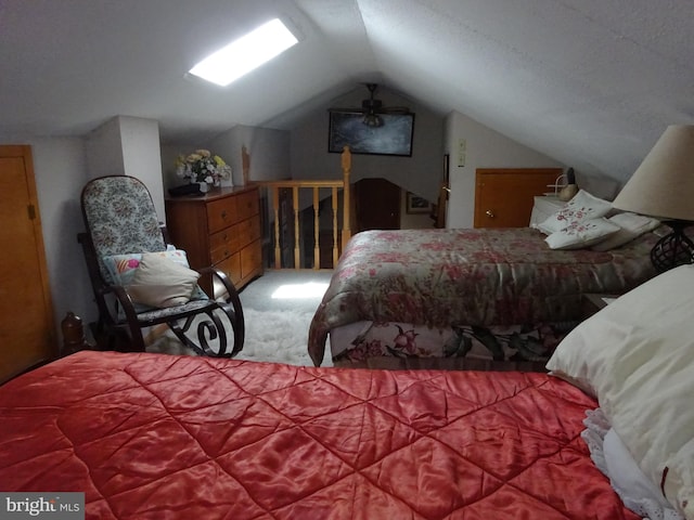 carpeted bedroom with lofted ceiling