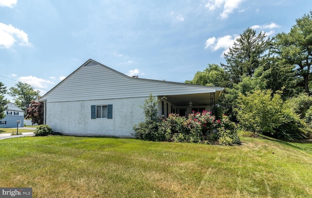 view of side of home featuring a yard