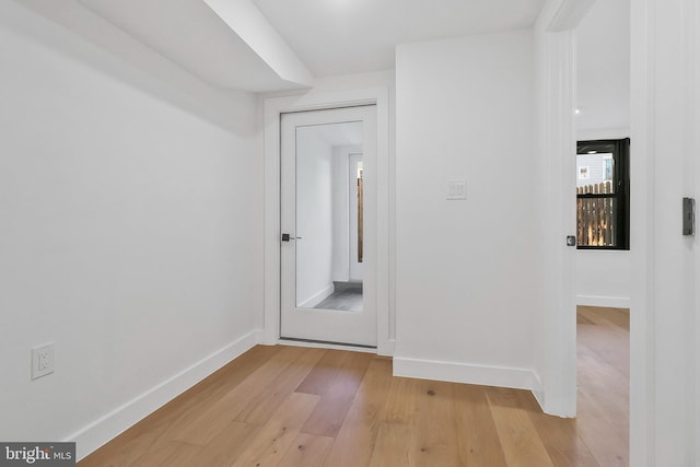 corridor with light hardwood / wood-style flooring