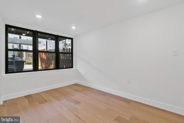 unfurnished room featuring a healthy amount of sunlight and light hardwood / wood-style flooring