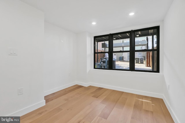 spare room with hardwood / wood-style floors