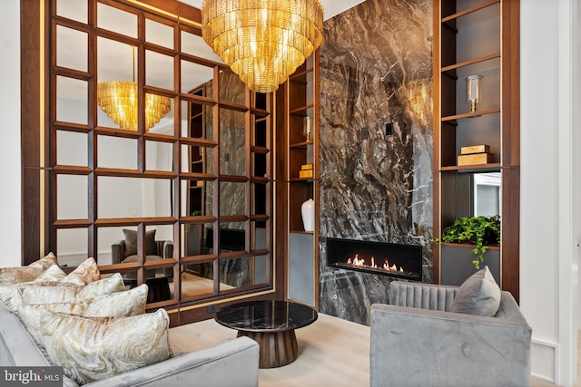 interior space with a high end fireplace, built in features, and a notable chandelier