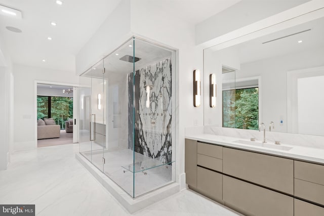 bathroom featuring a wealth of natural light, vanity, and a shower with shower door