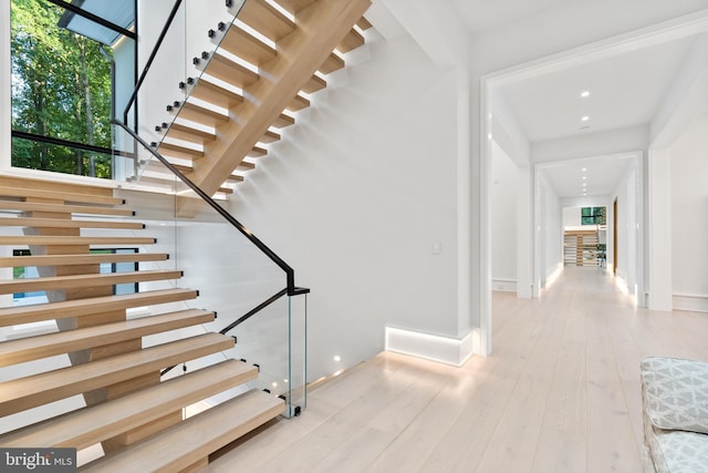 stairs with hardwood / wood-style floors