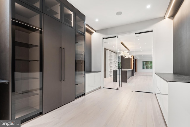 corridor with light hardwood / wood-style floors