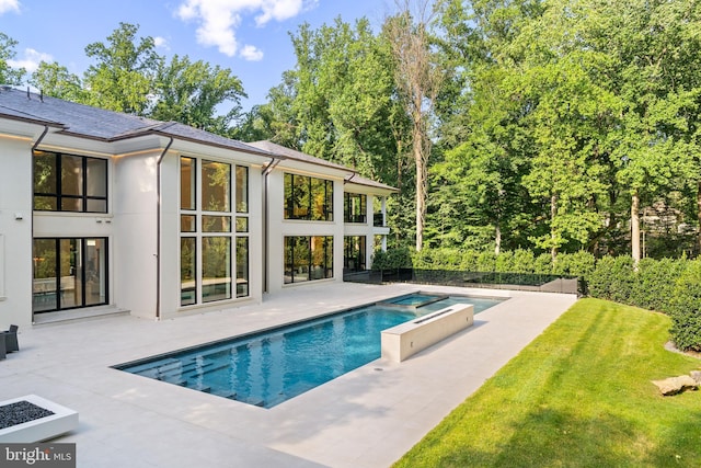 view of pool featuring an in ground hot tub and a patio