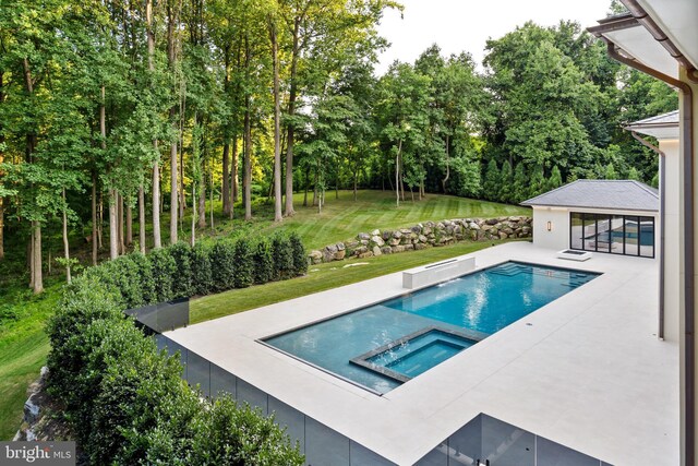 view of swimming pool featuring a patio area, a yard, and an in ground hot tub