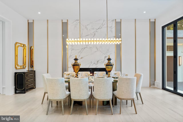 dining space with light hardwood / wood-style floors