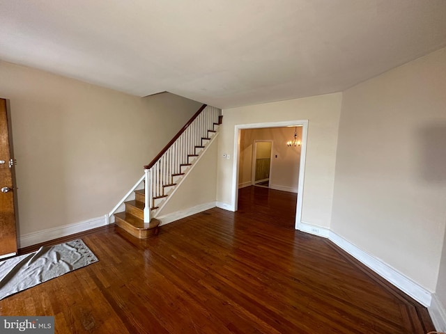 empty room with dark hardwood / wood-style floors