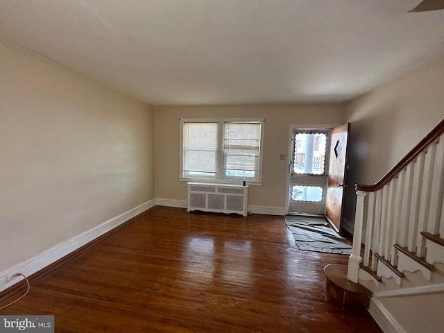 entryway with radiator heating unit and dark hardwood / wood-style floors